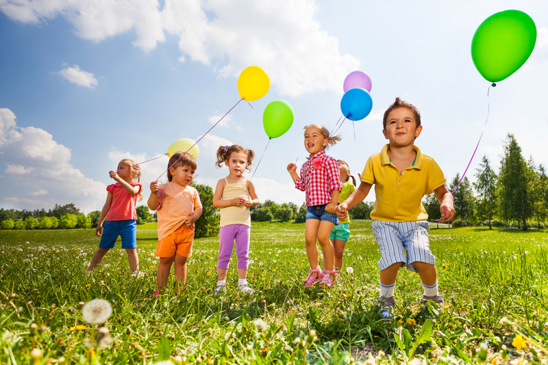 Children with colorful balloons running in field Children with colourful balloons running in field in summer